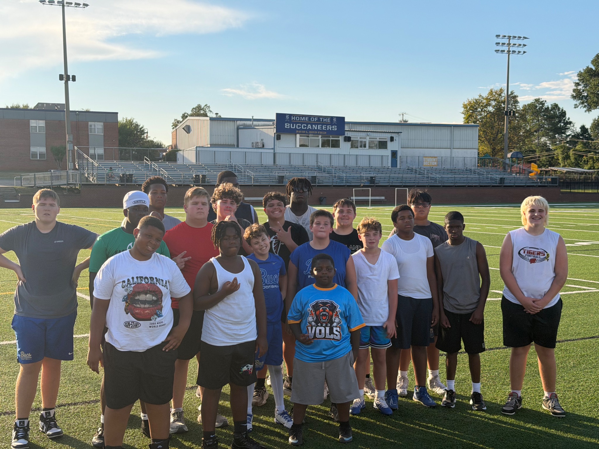 Big Man U youth athletes together on a football field